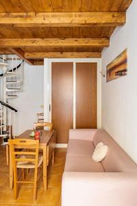 a living room with a couch and a table at Monolocale "Duomo" in Messina