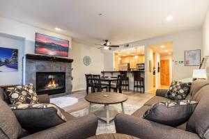 a living room with a couch and a fireplace at 2BDR Three Minutes to Olympic Valley in Tahoe City