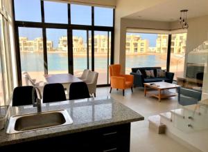 a kitchen and living room with a view of the ocean at Emos Villa in Hurghada