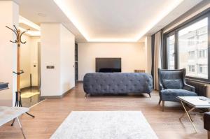 a living room with a couch and a chair at Luxury apartment in the heart of Nisantasi in Istanbul