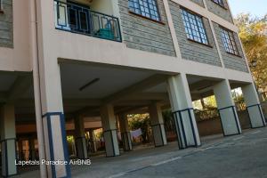a building with columns and windows on a street at Lapetals-Paradise-3bedrooms-ABNB machakos town in Machakos
