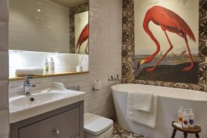 a bathroom with a sink and a toilet and a tub at The Lark - High Style by the Roman Baths in Bath