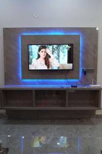 a flat screen tv sitting on top of a table at luxurious Family Apartment in Karachi