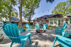 a group of blue chairs sitting around a fire pit at Ocean Springs Home with Fire Pit and Game Room! in Biloxi