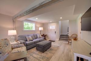 a living room with a couch and a table at Cozy Pierson Paradise Lake Retreat with Fire Pit! in Howard City