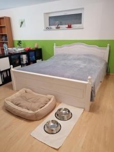 a bedroom with a bed with two plates on the floor at Ferienwohnung Borger in Sauerlach