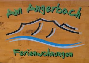 a table with a sign that reads im energed fernumber at Am Angerbach in Oberstaufen