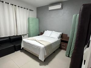 a small bedroom with a bed and a window at Casa Búzios - Temporada in Búzios +30 photos