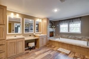 a bathroom with two sinks and a bath tub at Many Waterfront Vacation Rental with Boat Launch! in Alliance