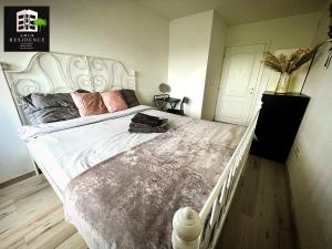 a bedroom with a large bed with a white headboard at AmurResidence privat-Sauna City Center FamilyConcept in Iaşi