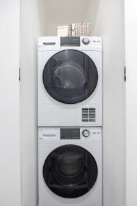 a washing machine and a dryer in a room at SWJ G - Save on 2Day or more Stays 25min to Times Sq in New York