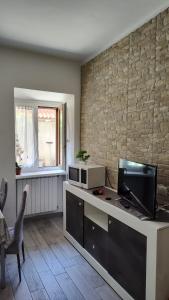 eine Küche mit einer Theke mit einer Mikrowelle und einem TV in der Unterkunft Appartamento nel cuore di Varese in Varese