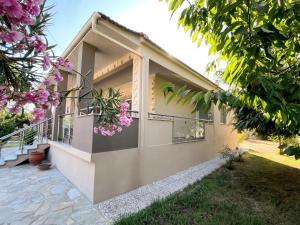 a house with pink flowers on the side of it at Eva's Summer House - ADAMOS HOLIDAYS in Fourka