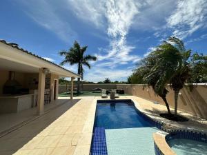 a swimming pool in front of a house at Casa Búzios - Temporada in Búzios