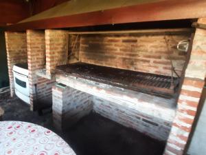 a brick fireplace in a room with a table at Flor de Lis apartmento in Mar del Plata