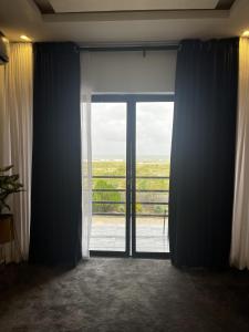 an open glass door with a view of a balcony at Seaview Palace in Lekki