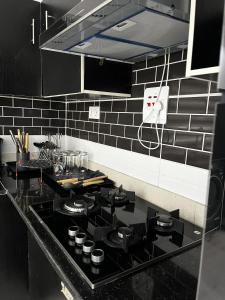 a kitchen with a black stove top in a kitchen at Seaview Palace in Lekki