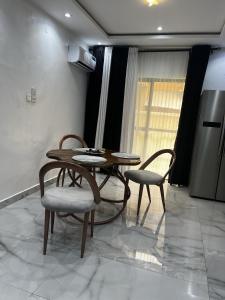 a dining room with a table and two chairs at Seaview Palace in Lekki