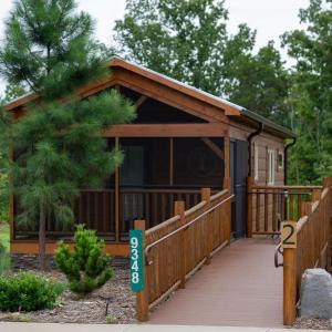a small cabin with a wooden walkway leading to it at Juneberry Ridge in Norwood