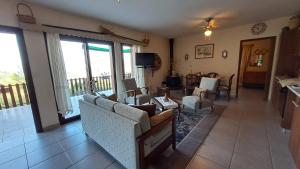 a living room with a couch and chairs and a balcony at Mountain View 2BR House with Garden & Free Parking Ioannis Ylation Saranti in Nicosia +35 photos