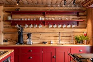 a kitchen with wooden walls and a red counter top at Valseter in Sør-Fron