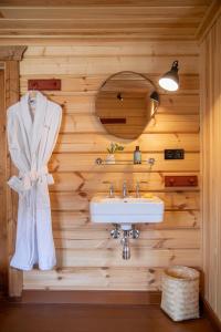 a bathroom with a sink in a wooden wall at Valseter in Sør-Fron