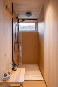 a bathroom with a shower and a wooden table at Valseter in Sør-Fron