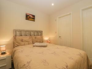 a bedroom with a large bed in a room at Deers Leap in Lydney