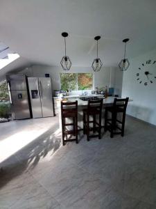 a kitchen with a table and chairs and a refrigerator at Finca de recreo Claro de Luna in Copacabana