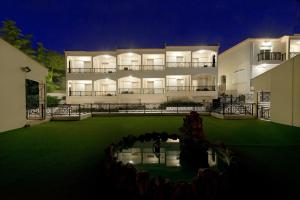 a large building with a lawn in front of it at Amalia in Paleo Tsifliki