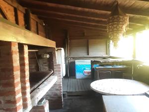 an empty kitchen with a table and a stove at Flor de Lis room #1 in Mar del Plata +22 photos