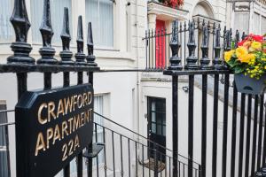 a sign on a fence in front of a building at Crawford Square Apartment in Derry Londonderry