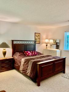 a bedroom with a bed and a table and a lamp at Red Robe B&B in Nanaimo