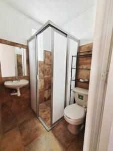 a bathroom with a toilet and a sink at Casa Juárez 2 in Oaxaca City