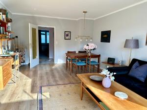 a living room with a couch and a table at Schöne Aussicht! in Langelsheim