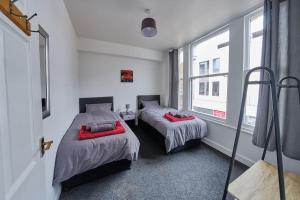 a bedroom with two beds and a window at Central flat in Basingstoke in Basingstoke