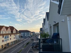 a view from a balcony of a street with buildings at Appartement Stella-Plage in Cucq