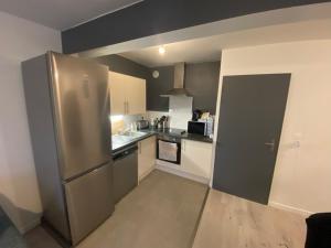 a kitchen with a large stainless steel refrigerator at Appartement Stella-Plage in Cucq