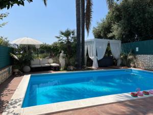 a swimming pool in a yard with at B&B Euthalia in Riposto