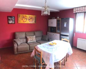 a living room with a table and a couch at Casa Valle in Cangas de Onís