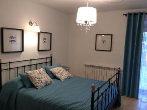 a bedroom with a bed and a chandelier at Juli's Place in Rovinjsko Selo