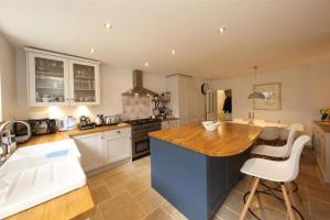 a kitchen with a wooden counter top in a room at Perfectly Positioned Pad in Cardiff