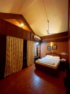 a bedroom with a large bed in a room at Beautiful Beach Front Villa - Beach Castle Homestay in Udupi +13 photos