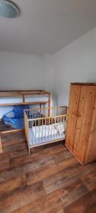 a room with two bunk beds and a wooden floor at Apartmán Kořenov in Kořenov