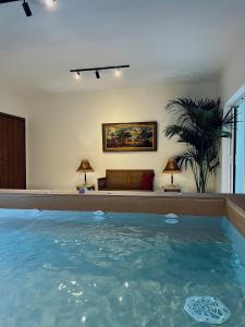 a large swimming pool in a room with a couch at THREE GRACES ZAKYNTHOS TOWN in Zakynthos Town