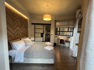 a bedroom with a bed and a desk in a room at METEORITO central apartment in Kalabaka