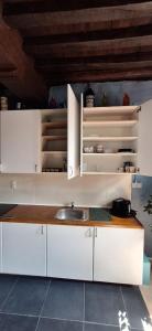 a kitchen with white cabinets and a sink at The 16th Century 2BR Apartment in The City Center in Antwerp