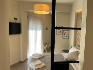 a room with a living room with a window and a couch at METEORITO central apartment in Kalabaka