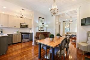 a kitchen and living room with a wooden table and chairs at Isaac LaRoche Estate in Savannah