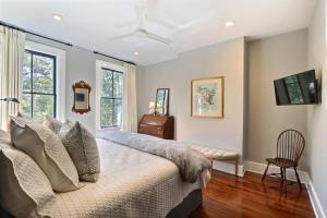 a bedroom with a bed with a ceiling fan at Isaac LaRoche Estate in Savannah